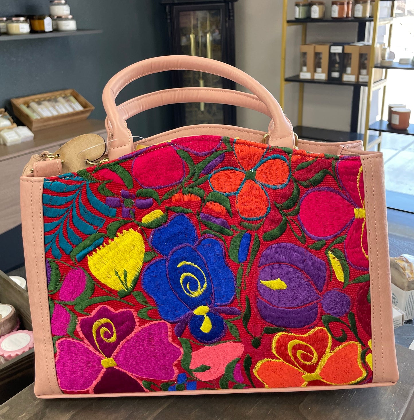 Colorful handbag with floral design on a table