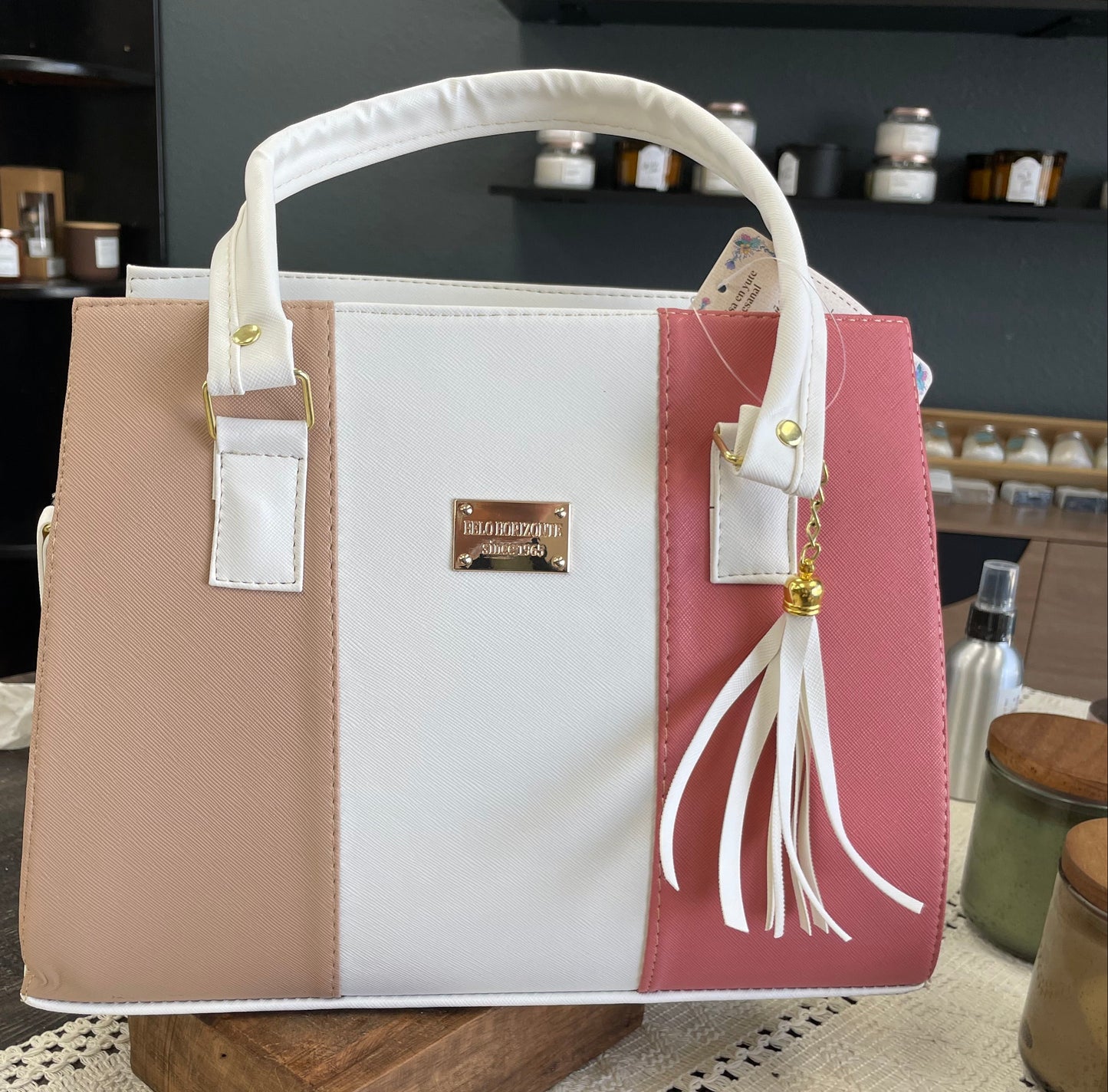 Handbag with visible brand label on a textured surface